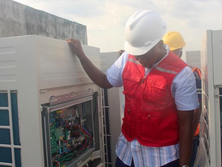 Engineer working inside a VRF control panel